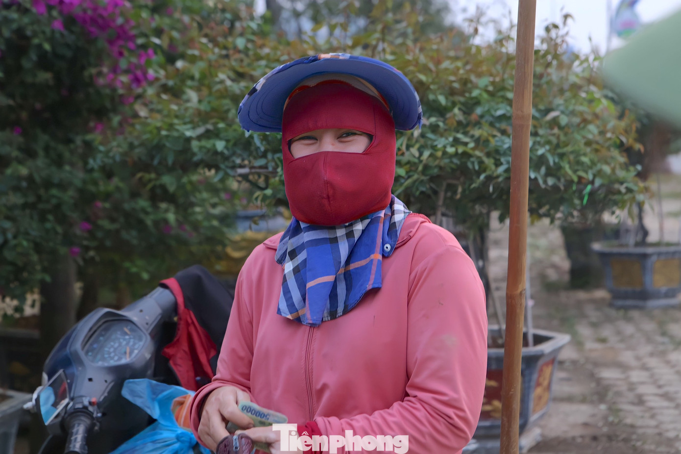 Người phụ nữ vui mừng khi nhận tiền được trả công sau 8h làm việc mệt nhọc. Với họ những ngày cuối năm có việc là thêm nguồn thu nhập trang trải cuộc sống, mua sắm vật dụng, đồ ăn chuẩn bị Tết...