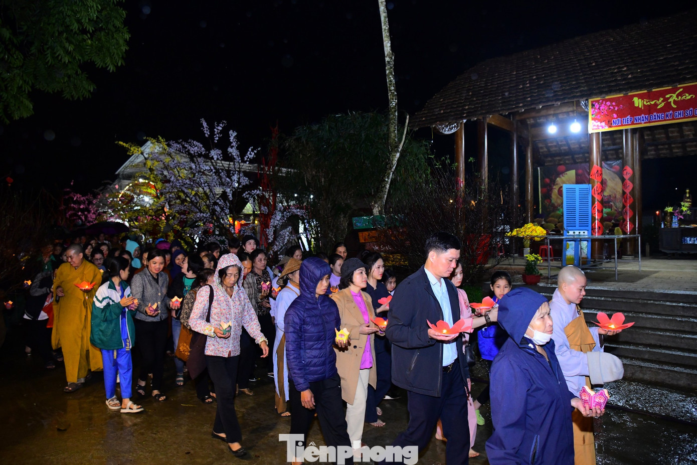 Cầm trên tay hoa đăng, người dân di chuyển từ chùa đến bờ sông để thả đèn mới mong muốn gửi đi những điều may mắn trong năm mới. Cầm trên tay hoa đăng, người dân di chuyển từ chùa đến bờ sông để thả đèn mới mong muốn gửi đi những điều may mắn trong năm mới.