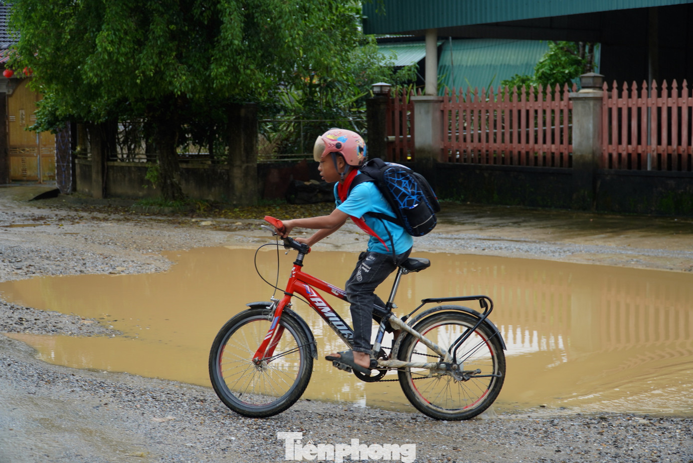 Các em học sinh gặp khó khi di chuyển trên đoạn đường đã hư hỏng.