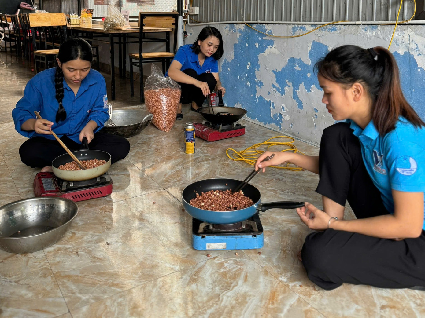 Lực lượng đoàn viên thanh niên cùng chế biến lạc rang để đóng gói chuẩn bị vận chuyển ra vùng lũ.