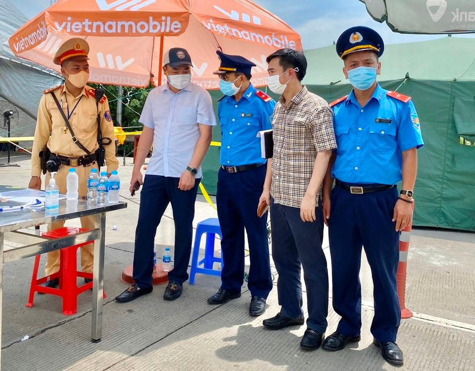 Phó Giám đốc Sở GTVT Hà Nội Đào Việt Long (thứ 2, từ trái sang) kiểm tra và động viên liên ngành TTGT-CSGT kiểm soát xe “luồng xanh” chốt cửa ngõ Pháp Vân (phía Nam) tháng 7/2021. Ảnh: T.Đảng