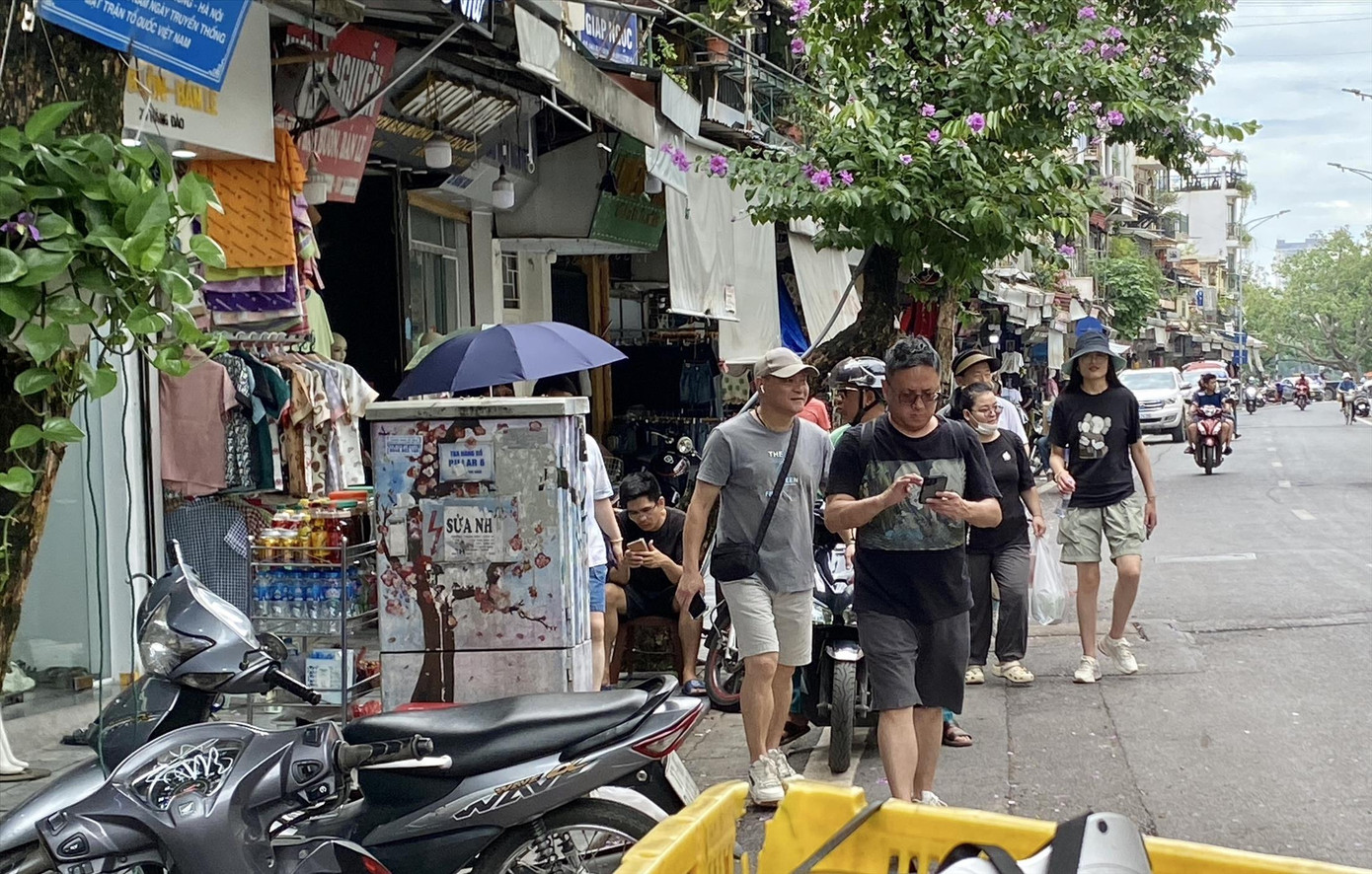 Vỉa hè một số tuyến phố ở quận Hoàn Kiếm bị chiếm dụng, du khách phải xuống lòng đường. Ảnh: Nguyễn Hải