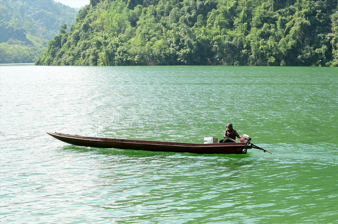 Cô Nụ và chiếc thuyền sắt của mình nhiều năm qua đưa đón học sinh vùng lòng hồ sông Đà. Ảnh: Xuân Tùng