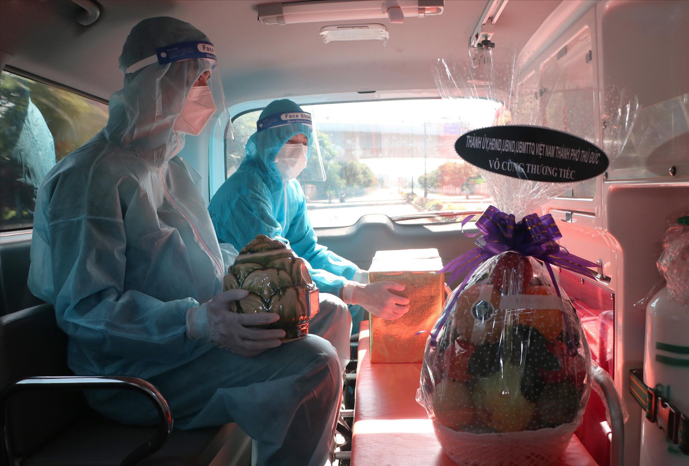 Các quân nhân ngồi trầm lặng trên xe, ôm chặt hũ tro cốt của người dân