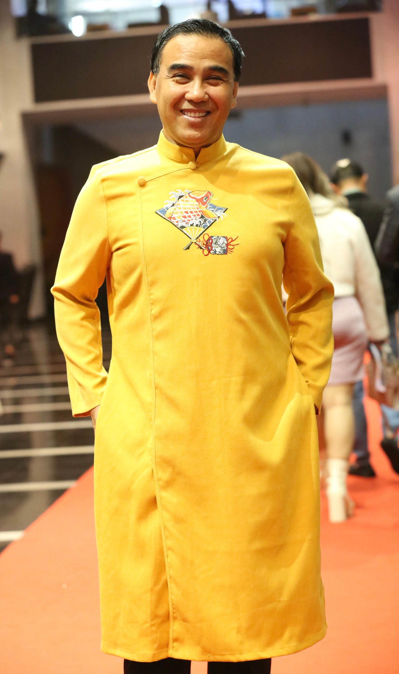 NSƯT Quyền Linh trong chiếc áo dài vàng rực rỡ. Anh và NSƯT Xuân Bắc chính là hai nam nghệ sĩ "bảnh" nhất thảm đỏ. Xuân Bắc diện áo dài đỏ rực đúng không khí Tết. Cả hai đều được nhiều đồng nghiệp trẻ xin chụp ảnh cùng.