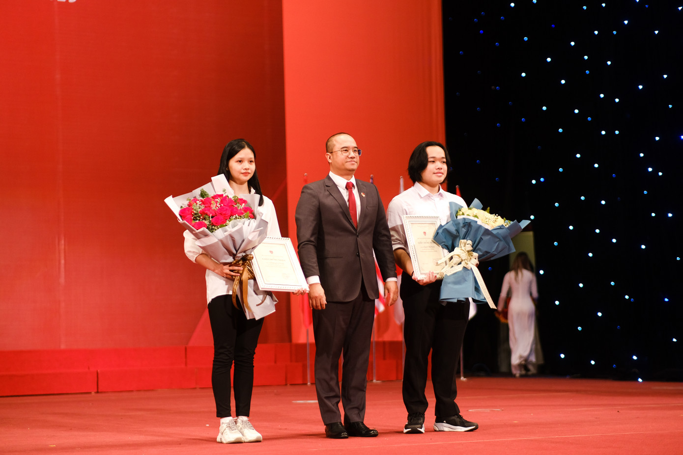 Khen thưởng 2 thủ khoa đầu vào năm 2023 của UEB là bạn Dương Lệ Tuyết (thủ khoa kỳ thi ĐGNL) và bạn Quách Thế Mạnh (thủ khoa xét tuyển chứng chỉ Tiếng Anh quốc tế). Ảnh: Lê Vượng