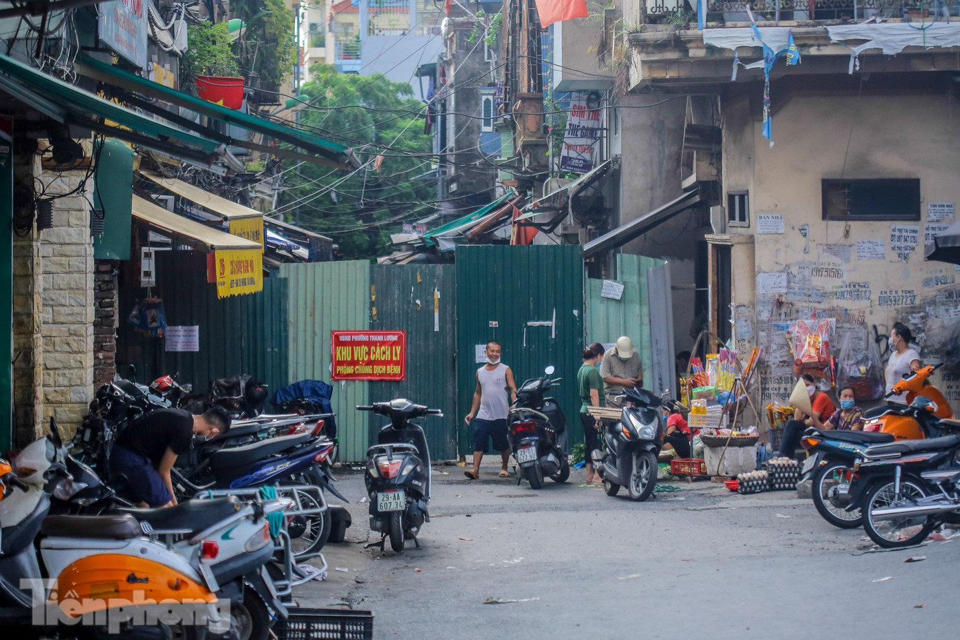 Một chốt cứng được rào bằng tôn chặn lối vào Đê Trần Khát Chân từ đường Nguyễn Khoái. Bên ngoài cảnh sinh hoạt tập nập sau nới lỏng giãn cách.