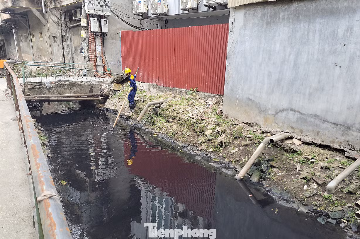 Công nhân của xí nghiệp thoát nước đang thực hiện vớt rác hằng ngày tại mương Thụy Khuê