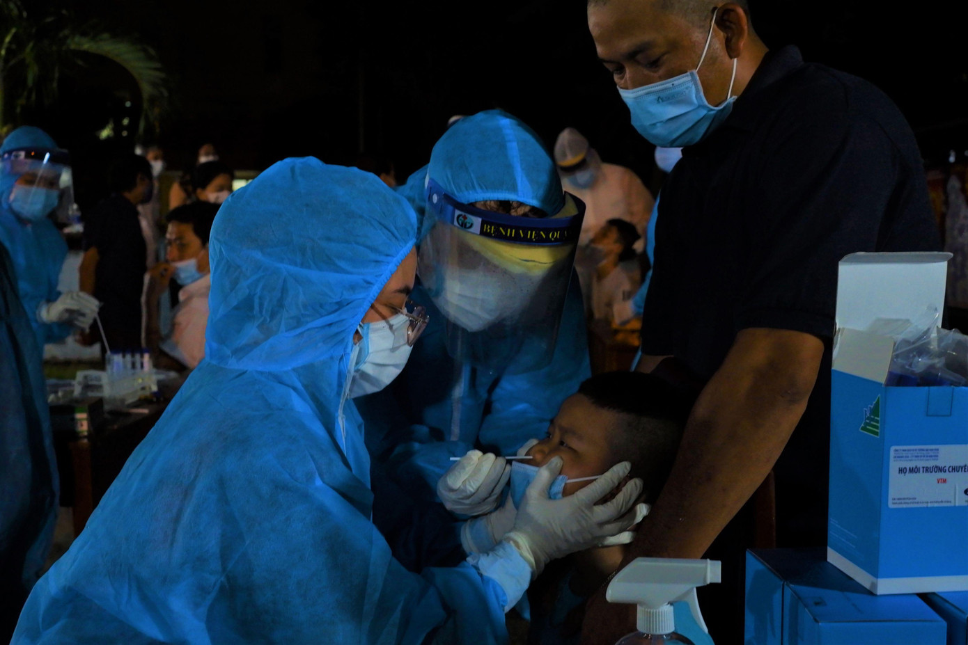 Để những đứa trẻ ngồi yên lấy mẫu, nhân viên y tế dùng mọi cách làm cho bé tập trung như tập đếm từ 1 đến 10....