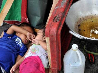 Những đứa trẻ ngủ bên chảo dầu trên một con phố ở thủ đô Manila, Phillippin