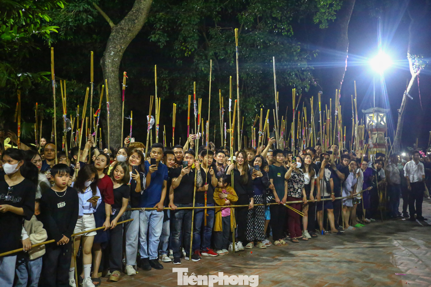 Hàng ngàn người dân và du khách đứng chờ ở khu lăng mộ Chu Bá dùng sào tre buộc hương để lấy chuẩn bị lấy lửa thiêng.