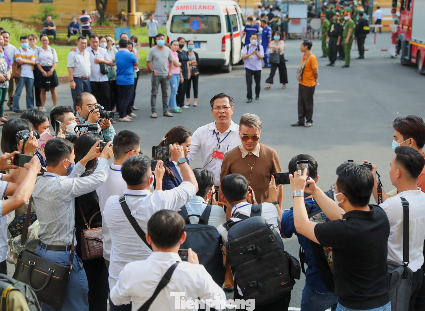 Ca sỹ Đàm Vĩnh Hưng và luật sư đi theo bị bao vây bởi truyền thông ngay khi xuất hiện phía trước toà.