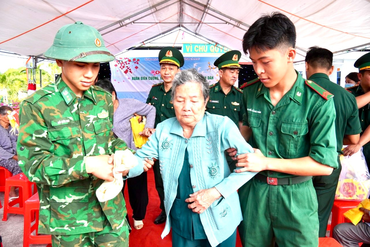 Cán bộ, chiến sĩ hỗ trợ người dân khám bệnh.