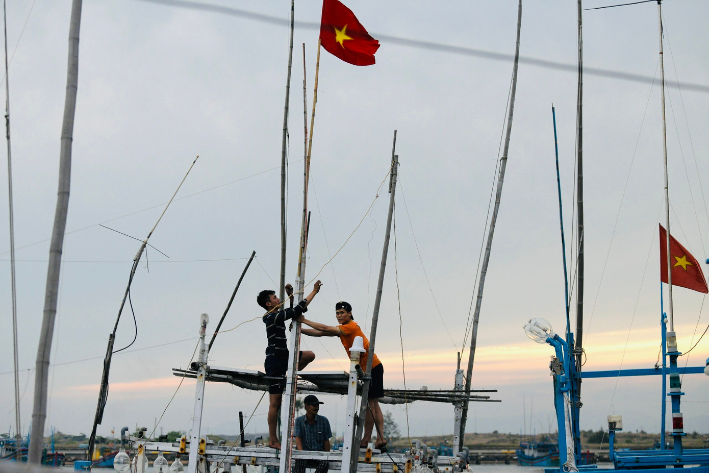 Các ngư dân thay cờ trên thuyền chuẩn bị cho những chuyến biển tiếp theo. Các ngư dân thay cờ trên thuyền chuẩn bị cho những chuyến biển tiếp theo.
