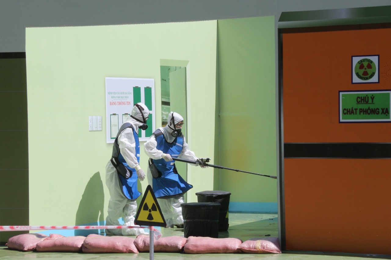 Trong tình huống giả định, lực lượng PCCC&amp;CNCH phối hợp với Bệnh viện Ung bướu Đà Nẵng sử dụng thiết bị phát hiện và đo lường phóng xạ đa năng, đảm bảo bên ngoài hàng rào khoanh vùng suất liều nhỏ hơn 100uSv/h.