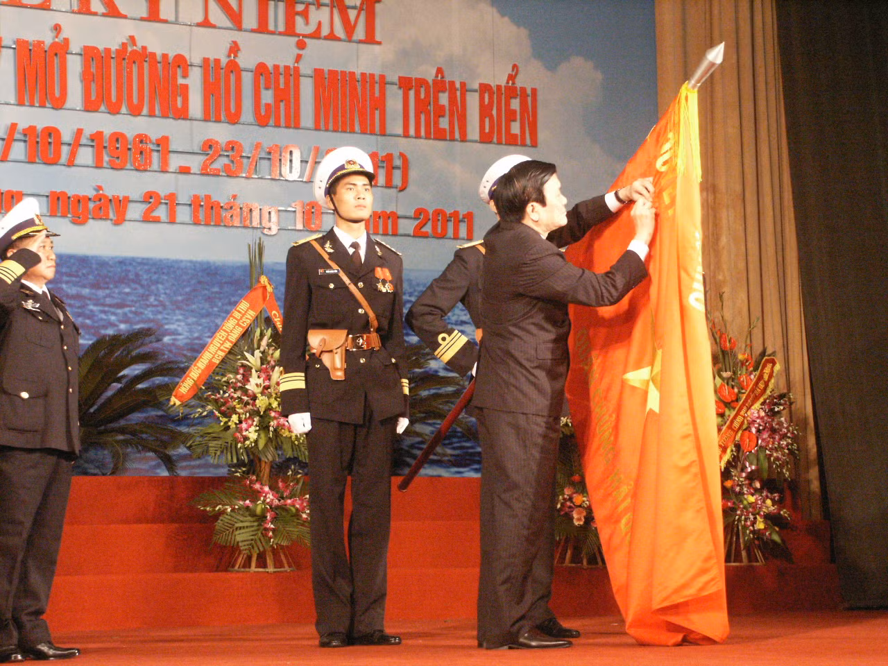 Chủ tịch nước gắn Huân chương Hồ Chí Minh lên lá cờ truyền thống hải quân Việt Nam.
