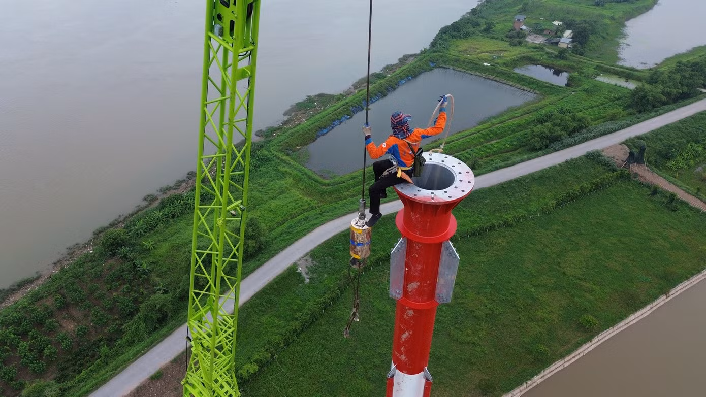 Những kỹ sư cheo leo "ôm trụ", giữa thời tiết nắng nóng như đổ lửa. Với tinh thần "vượt nắng, thắng mưa", các công nhân miệt mài làm việc để hoàn thành công trình như thời gian đã đề ra.