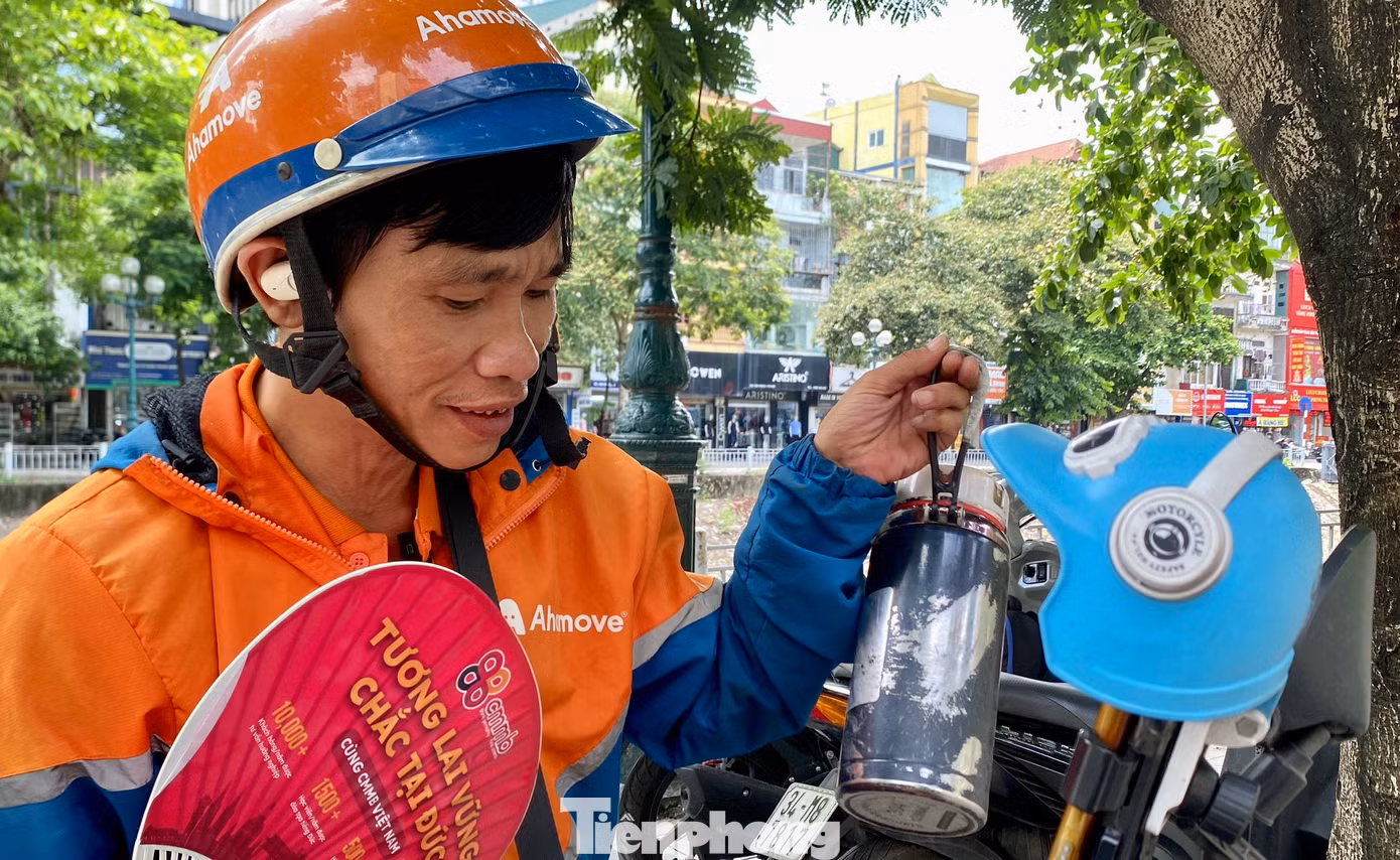 Với các tài xế xe công nghệ luôn phải di chuyển liên tục trên đường cả ngày, thì vật dụng để che nắng cho điện thoại, tránh nóng máy, phồng pin là không thể thiếu. Ngoài ra, anh Đinh Xuân Vinh (44 tuổi, Hà Nội) còn trang bị thêm bình nước đá giữ nhiệt, quạt tay để có thể làm việc nhiều tiếng dưới trời nắng nóng.