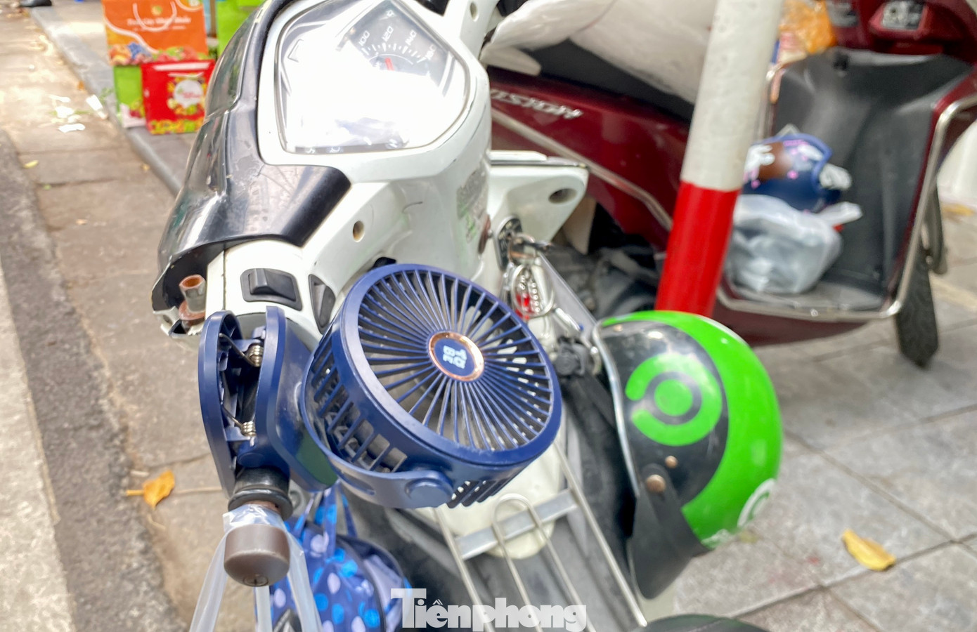 Một số người lao động sử dụng quạt điện mini được gắn ở tay cầm, hoặc dưới thanh sắt để đồ trên xe máy...