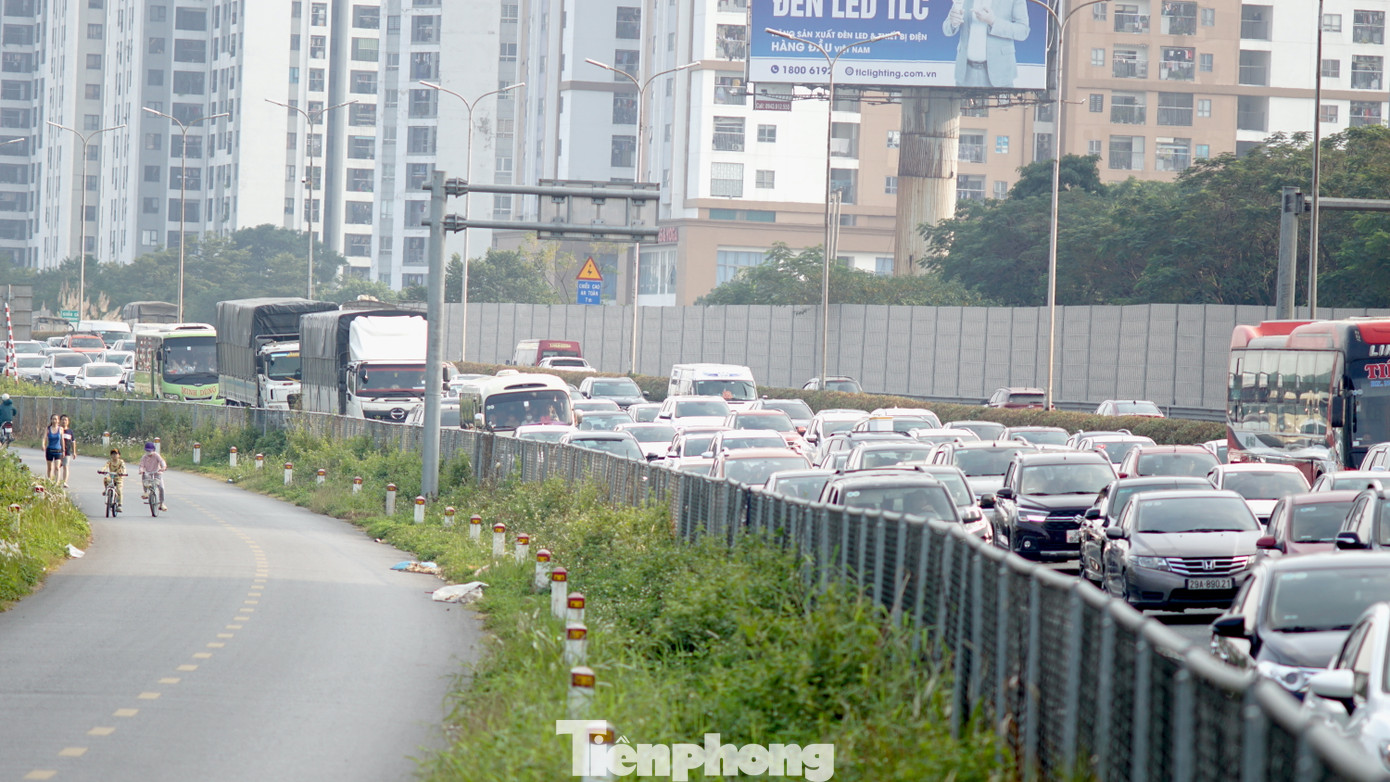 Trên cao tốc ô tô xếp thành 4 hàng di chuyển rất chậm, trong khi đó đường gom phía ngoài rất vắng.