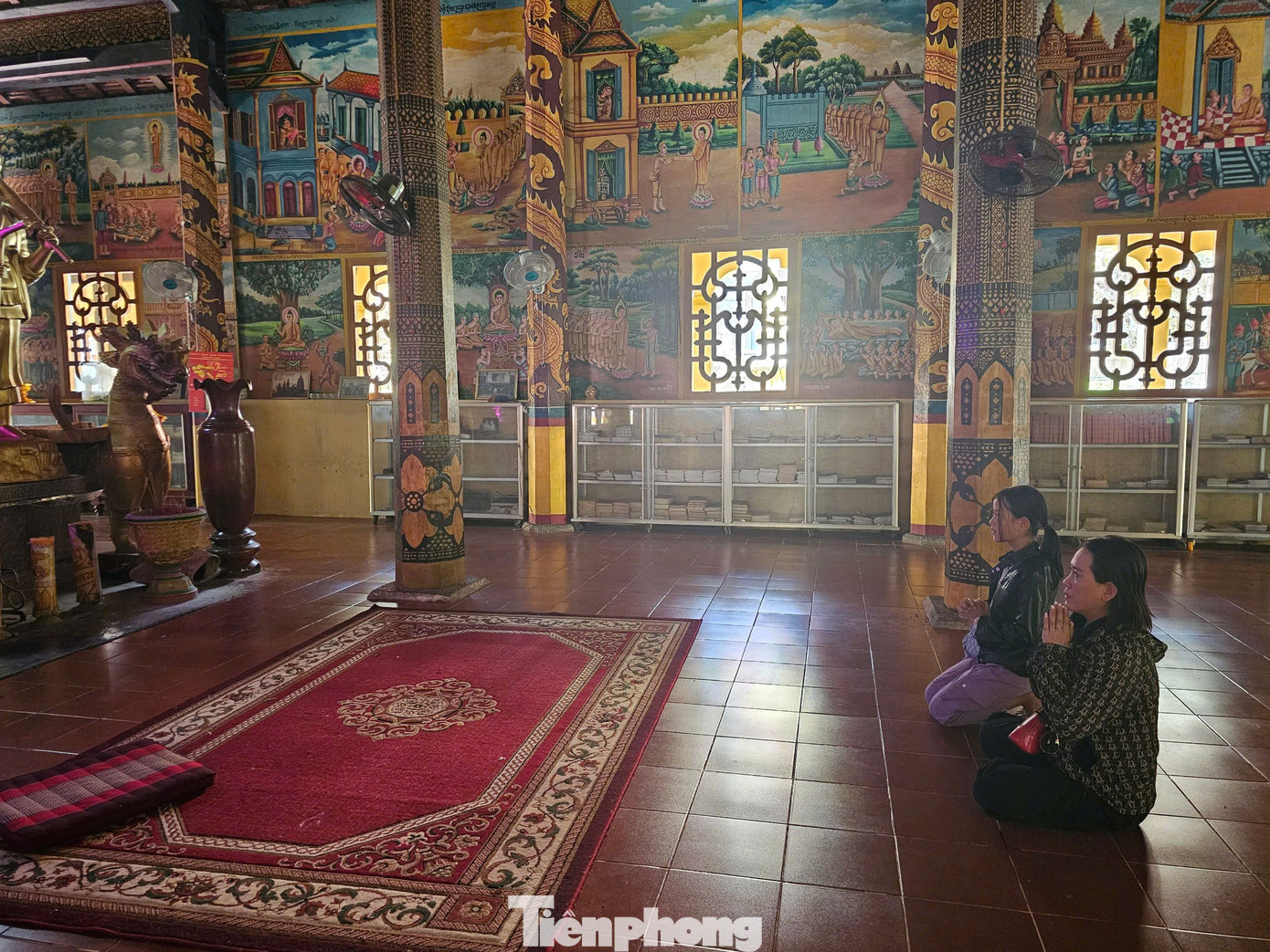 Phía trước bàn thờ Phật là bao lam bằng gỗ sơn son thếp vàng, được chạm khắc tinh xảo hình hoa lá, muông thú. Trong ảnh, người dân cầu nguyện tại chính điện chùa. Ảnh: Hòa Hội.