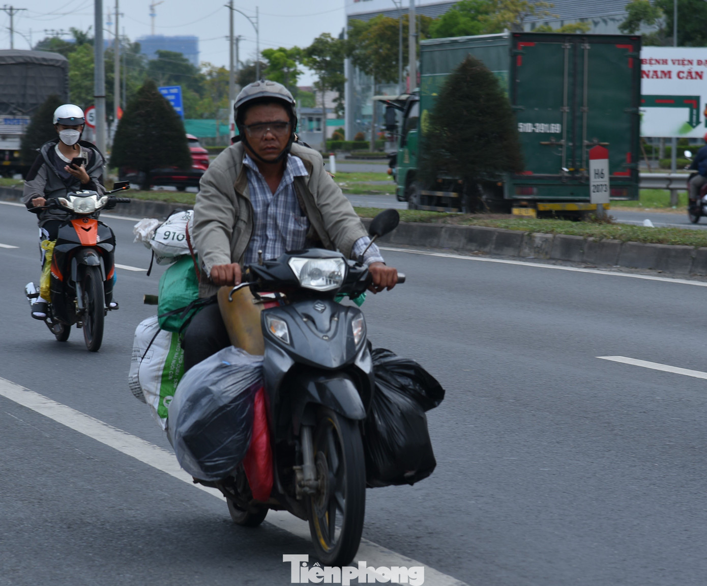 Đồ đạc lỉnh kỉnh trên xe gắn máy. Ảnh: Hòa Hội