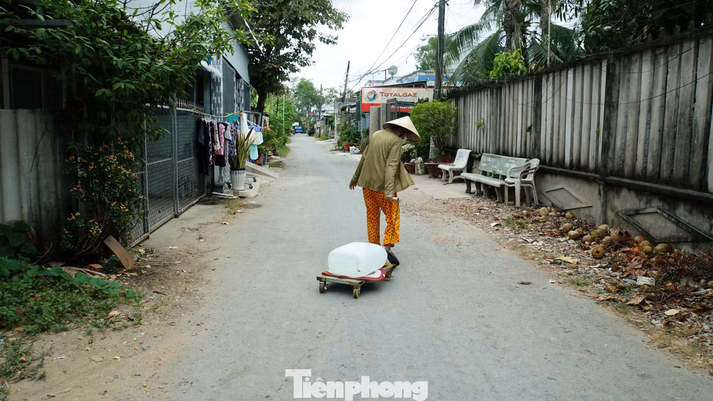 Cụ già kéo từng can nước mang về nhà sinh hoạt tại xã An Hóa, huyện Châu Thành, tỉnh Bến Tre. Ảnh: Hòa Hội