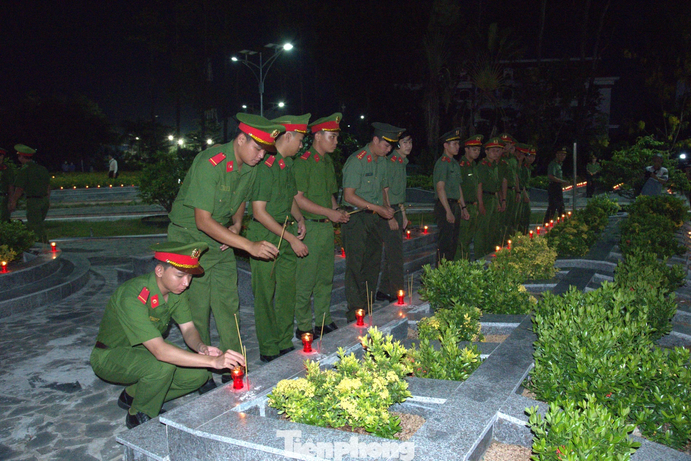 Chiến sĩ công an thắp nhang anh hùng liệt sĩ. Ảnh: Hòa Hội