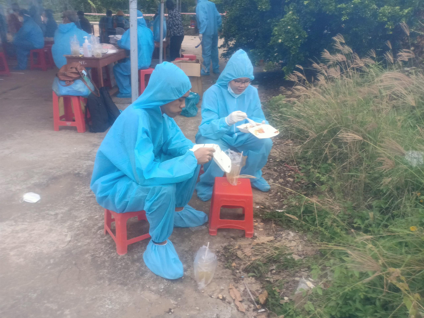 Trúc (bên phải) cùng đồng đội ăn vội cơm để tranh thủ làm việc tiếp Trúc (bên phải) cùng đồng đội ăn vội cơm để tranh thủ làm việc tiếp