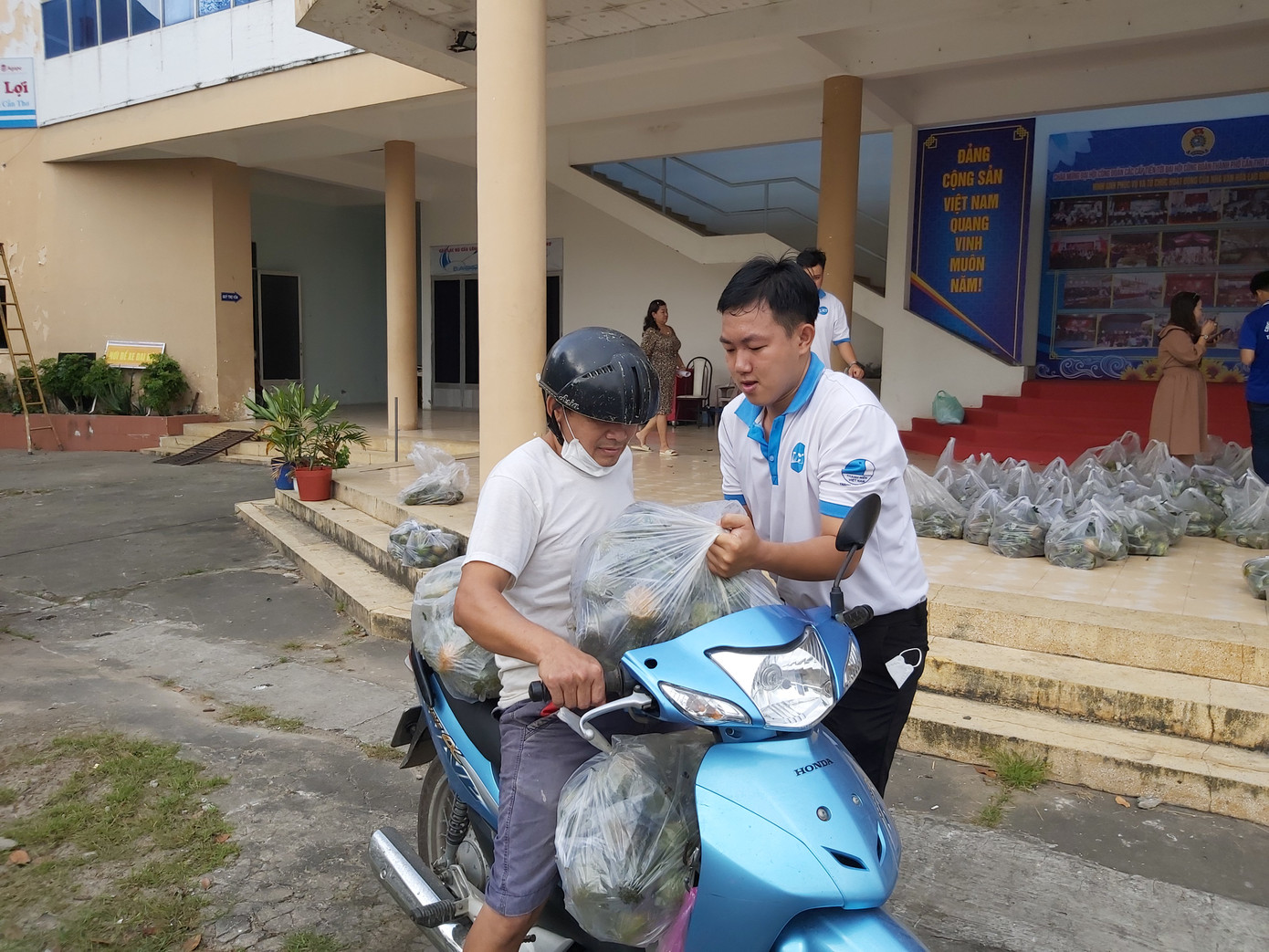 Các bạn tình nguyện viên hỗ trợ đưa cam lên xe.