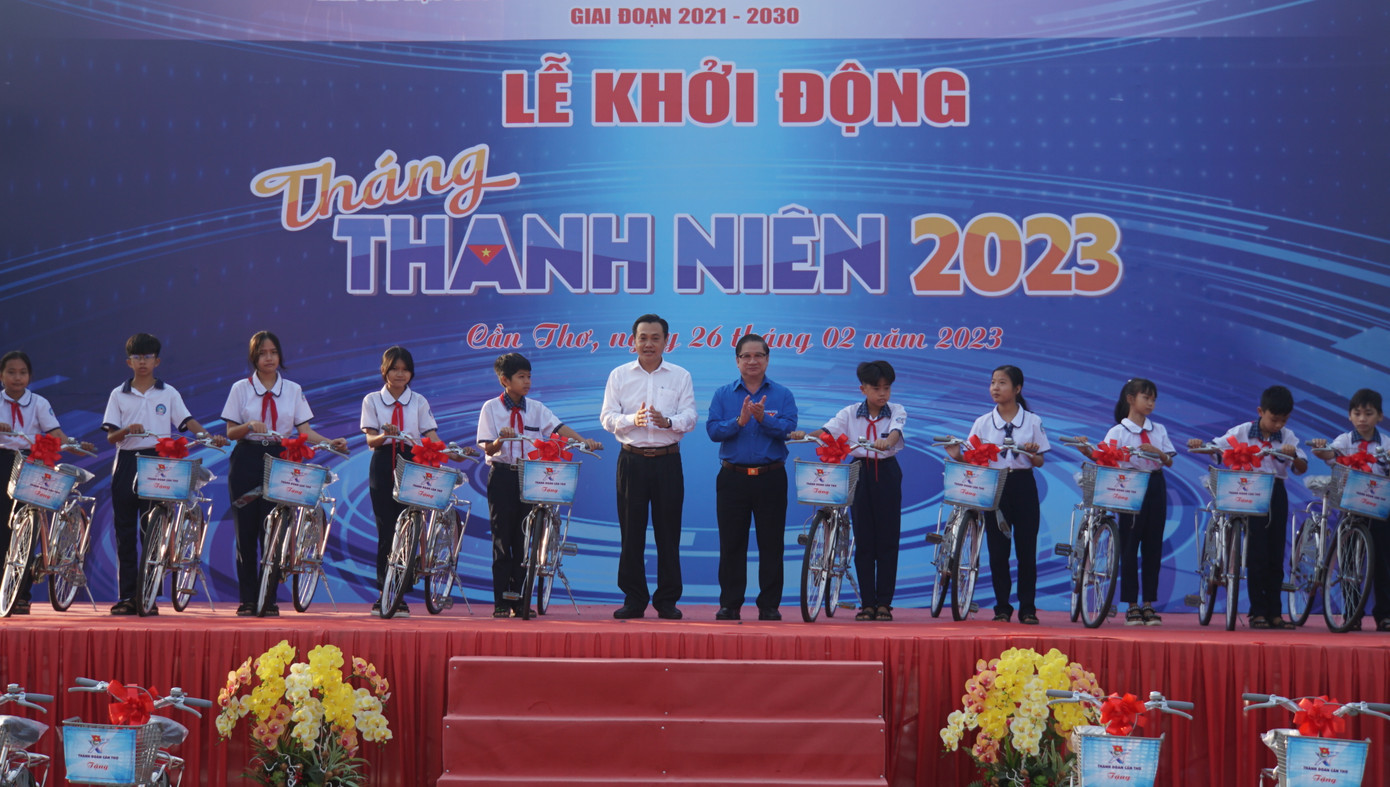 Chủ tịch UBND thành phố Cần Thơ Trần Việt Trường (áo xanh) tặng xe đạp cho học sinh tại huyện Thới Lai. Ảnh: Hòa Bình