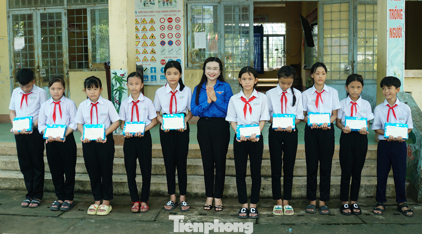 Chị Nguyễn Phạm Duy Trang tặng quà cho học sinh trường tiểu học Tân Kiều 2. Ảnh: Hòa Hội