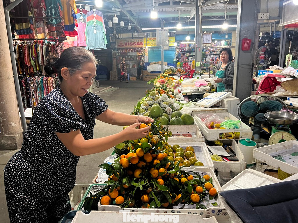 Sáng sớm 30 Tết (tức ngày 21/1), tiểu thương chợ An Nhơn (quận Gò Vấp, TPHCM) đã tất bật bày hàng chờ khách. "Hôm nay chợ 30 Tết nên chỉ bán đến trưa là dọn dẹp sạch sẽ nên chúng tôi dọn hàng từ sớm tinh mơ, để phục vụ khách mua đồ kịp cúng đón ông bà về ăn Tết" - bà Tâm, tiểu thương chợ An Nhơn chia sẻ.