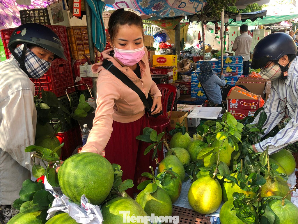 Bưởi da xanh được nhiều người chọn mua, giá hiện nay 120.000 đồng/kg (loại 1). "Tại siêu thị giá chỉ tầm 60.000 đồng/kg nhưng không có cuống lá, ngoài chợ tuy đắt gấp đôi nhưng lại đáp ứng yêu cầu nên tôi chọn mua. Hôm nay cuối năm rồi, tiểu thương không nhập hàng nữa nên hoa trái giá cả đều tăng" - chị Thủy (ngụ quận 5) cho hay.