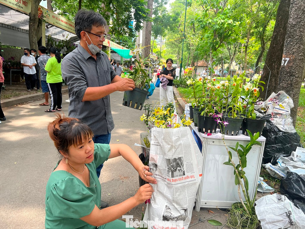 Nhân viên liên tục bó hoa cho khách. "Khách nhộn nhịp đến thưởng thức và mua hoa suốt ngày nên chúng tôi làm việc không ngơi tay. Trong hai ngày lễ 30/4 và 1/5, có thể số lượng khách sẽ còn tăng cao, nhất là buổi chiều tối" - chị Tâm (đại diện vườn lan ở TPHCM) cho biết.