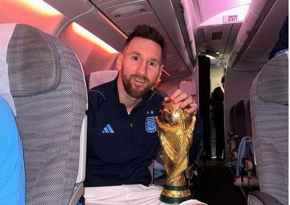 Messi cầm cúp trên chuyến bay trở về Argentina Messi cầm cúp trên chuyến bay trở về Argentina