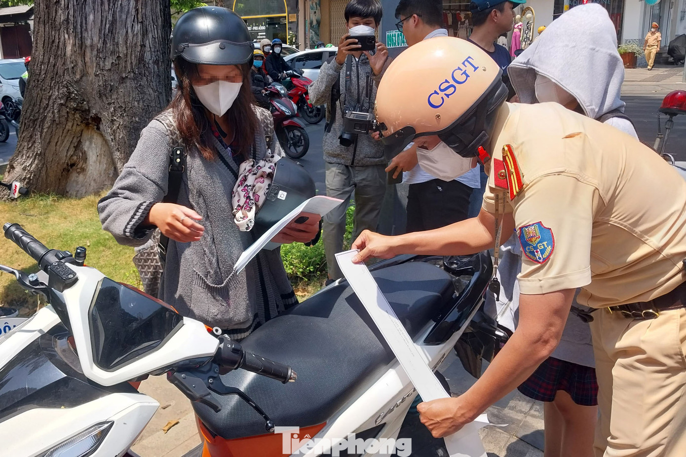 Tổ công tác dán niêm phong xe do em C điều khiển trước khi cho xe đưa về trụ sở tạm giữ.