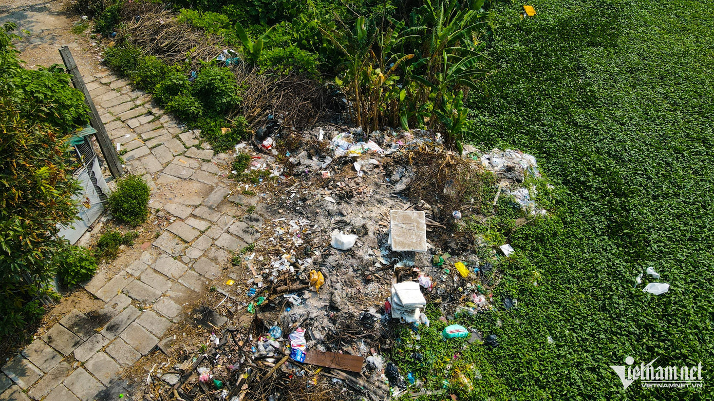 Những bãi phế thải lấn ra hồ trong ngõ 175 Định Công có thể thấy rất rõ. Đá vụn, rác thải được tập kết tại nhiều điểm ven đầm.