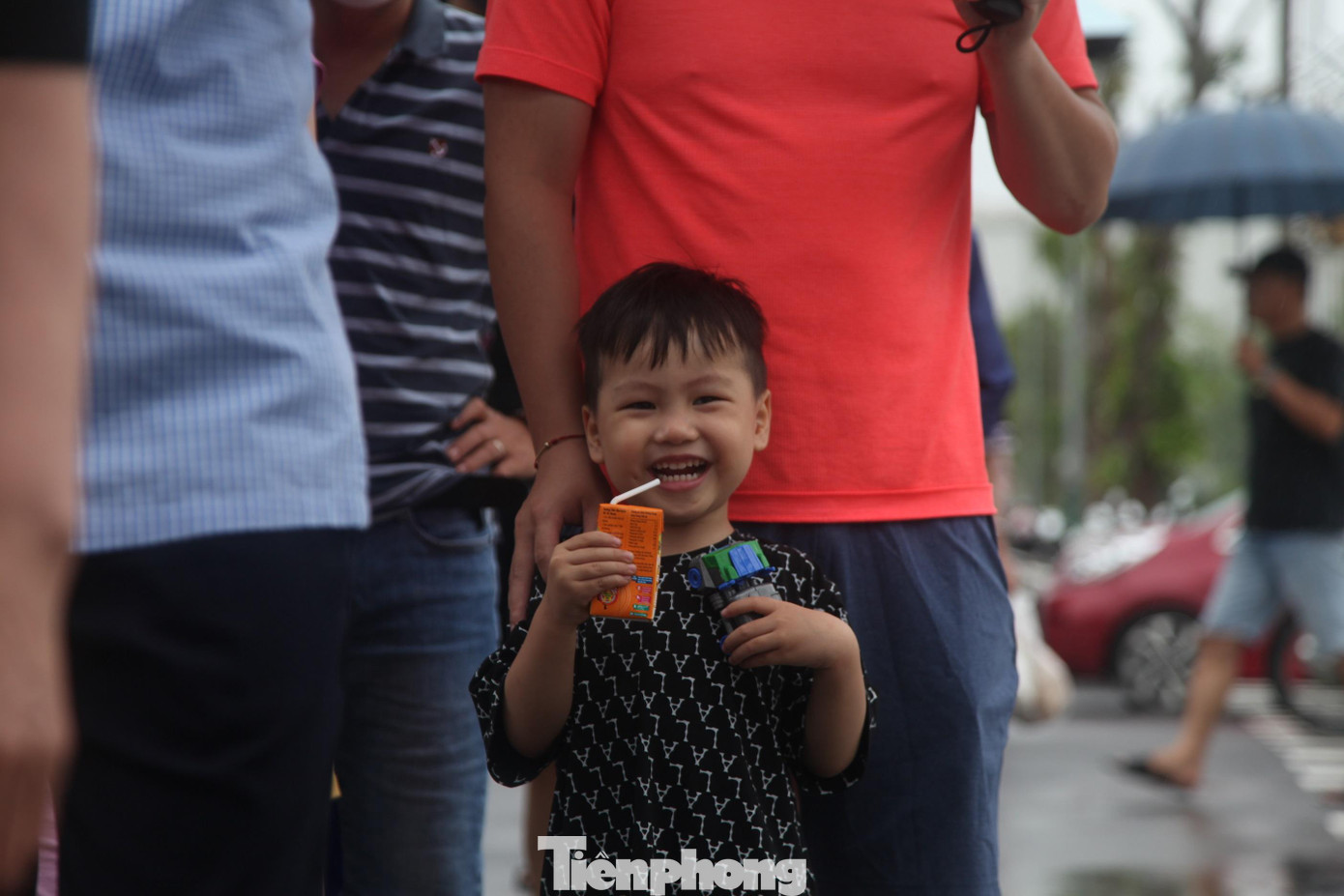 Nhiều em bé cũng đội mưa theo bố mẹ đi cổ vũ SEA Games 31