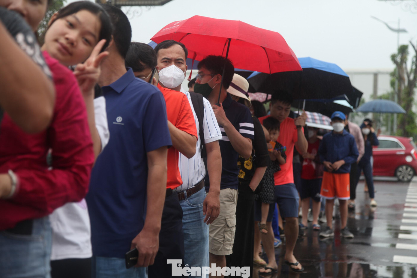 Người dân tỉnh Bắc Ninh xếp hàng dưới mưa để vào trong sân thi đấu cổ vũ cho các vận động viên quần vợt Việt Nam