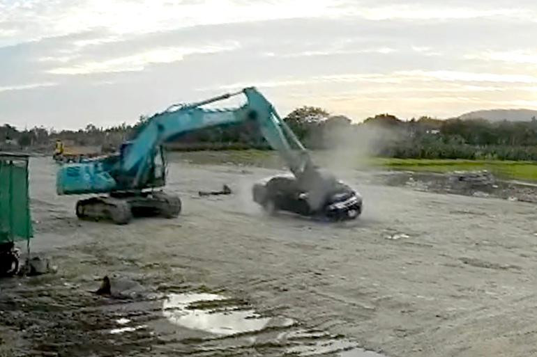 Xe ô tô bán tải bị xe máy xúc "bổ" liên tiếp 2 nhát khiến phần đầu biến dạng hoàn toàn (Ảnh cắt từ clip).