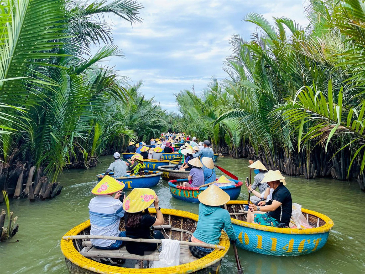 Nhiều thợ làm nhà tre, dừa chuyển sang nghề chèo thúng phục vụ khách tham quan rừng dừa nước. Ảnh: Nguyễn Trọng Tài