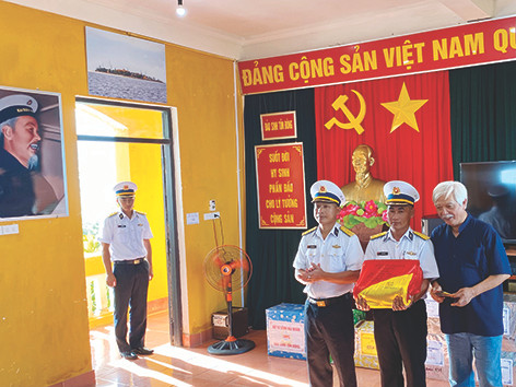 Trao lá cờ của Đồn Biên phòng Lũng Cú cho Chỉ huy trưởng và Chính trị viên đảo Sinh Tồn Đông. Ảnh: Lê Xuân Sơn Trao lá cờ của Đồn Biên phòng Lũng Cú cho Chỉ huy trưởng và Chính trị viên đảo Sinh Tồn Đông. Ảnh: Lê Xuân Sơn