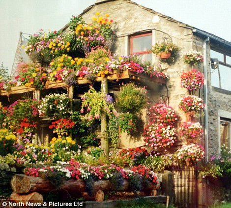 Ngôi nhà có nhiều chậu hoa treo trên tường