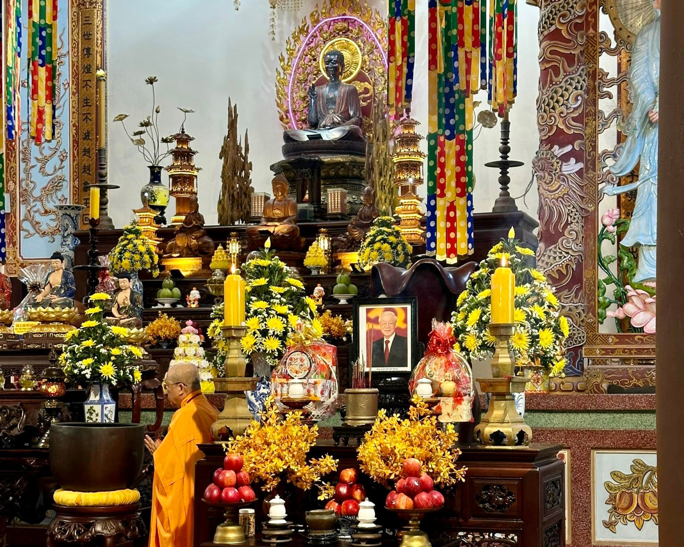 Di ảnh của Tổng Bí thư Nguyễn Phú Trọng được đặt trang nghiêm trong chánh điện, xung quanh bài trí hoa cúc vàng.