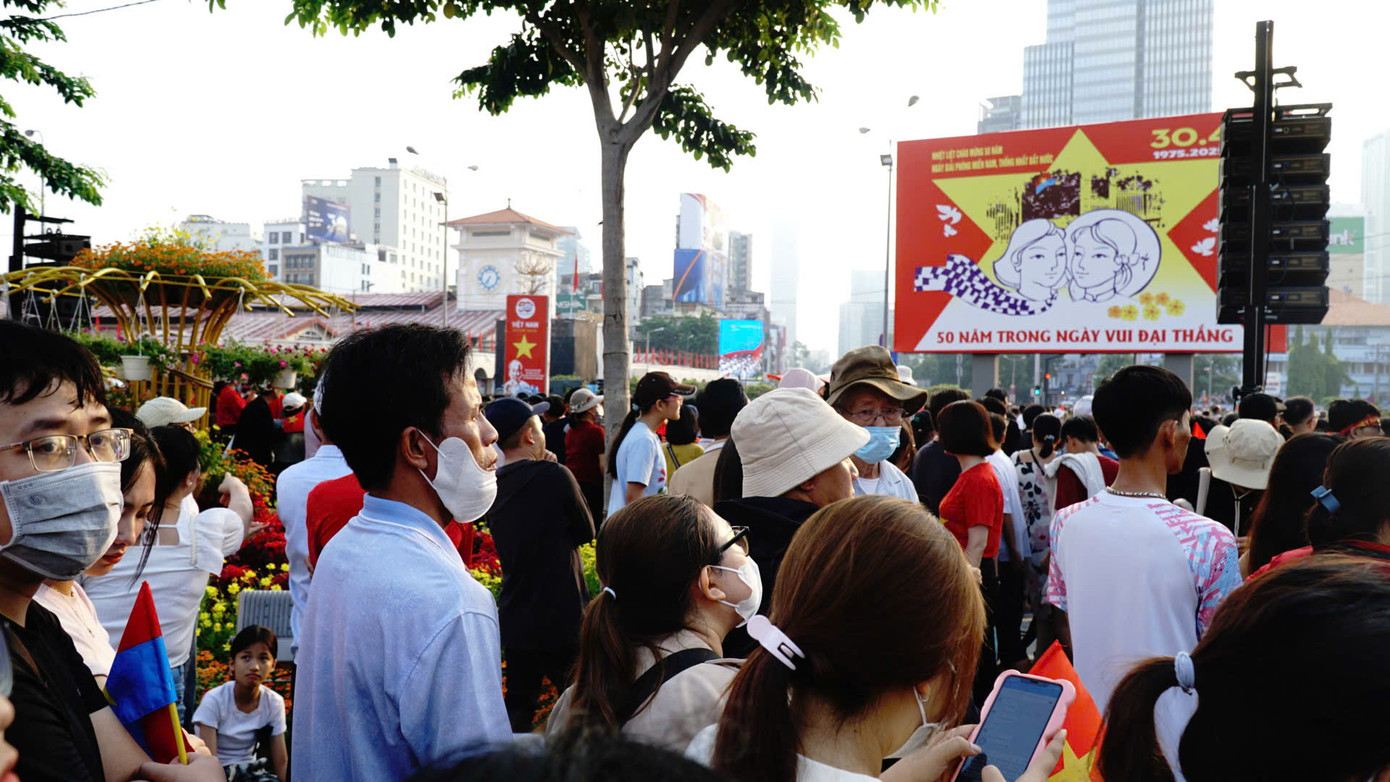 Người dân theo dõi lễ kỷ niệm qua màn hình LED được đặt trước chợ Bến Thành. Người dân theo dõi lễ kỷ niệm qua màn hình LED được đặt trước chợ Bến Thành.