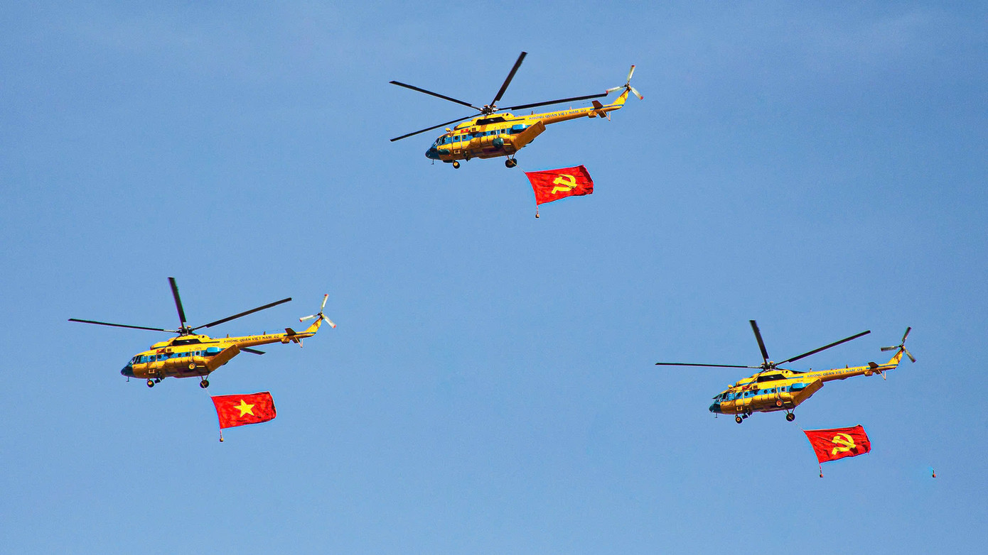 Những chiếc máy trực thăng mang cờ Tổ quốc và cờ Đảng. (Ảnh: Quang Vinh)