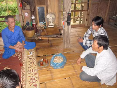 Ông lang Thầm (trái) trò chuyện với bệnh nhân. Ông lang Thầm (trái) trò chuyện với bệnh nhân