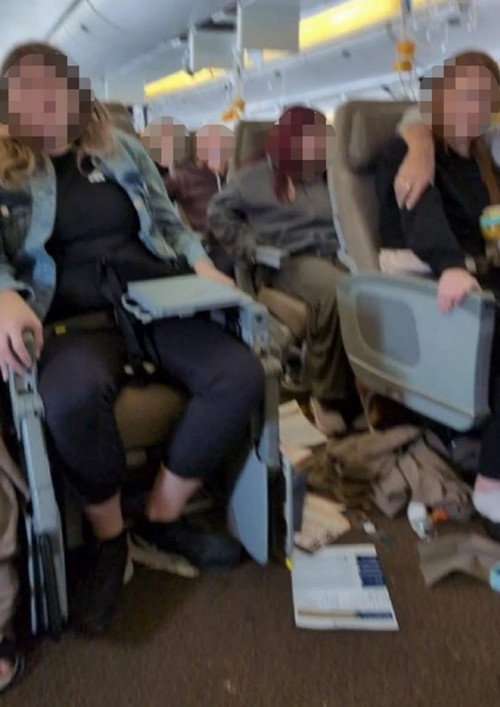 Hành khách sợ hãi bám chặt vào ghế sau khi máy bay giảm độ cao đột ngột. Ảnh: X/ Daily Star.