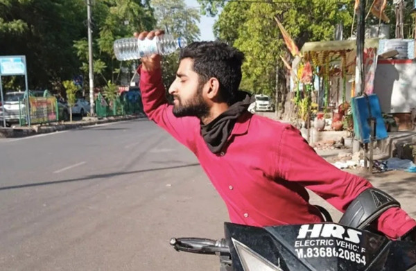 Một người giao hàng ở Ấn Độ đang đổ nước lên đầu cho đỡ nóng. Ảnh: Parthu Venkatesh/ Al Jazeera. Một người giao hàng ở Ấn Độ đang đổ nước lên đầu cho đỡ nóng. Ảnh: Parthu Venkatesh/ Al Jazeera.